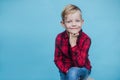 Handsome little boy with red shirt. Fashion. Studio portrait over blue background Royalty Free Stock Photo