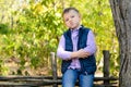Handsome Little Boy Sitting on Wooden Fence Royalty Free Stock Photo