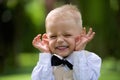 Handsome little boy in a suit to laugh outdoor