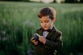 Handsome little boy with vintage retro camera. Kid as young photographer studying to take pictures. Hipster festive Royalty Free Stock Photo