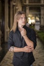 Handsome long hair young man indoors in elegant gallery