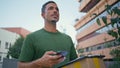 Handsome mailman delivering package greenery neighbourhood closeup. Mail courier Royalty Free Stock Photo