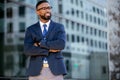 Handsome male african american business man CEO in a suit at the workplace, standing confidently with arms folded Royalty Free Stock Photo