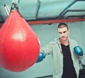 Handsome male boxer trains hand punches