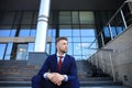 Handsome male business executive sitting on stairs outside a building. Royalty Free Stock Photo