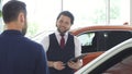 Handsome male car dealer talking to his male customer Royalty Free Stock Photo