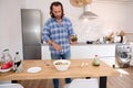 Handsome male chef cooking salad in the minimalist home kitchen Royalty Free Stock Photo