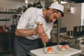 Handsome Male Chef in uniforms preparing sushi in a kitchen of asian restaurant Royalty Free Stock Photo