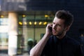 Handsome male confident entrepreneur calling via cellphone,standing outside Royalty Free Stock Photo