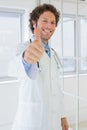 Handsome male doctor gesturing thumbs up Royalty Free Stock Photo