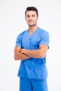 Handsome male doctor standing with arms folded