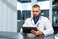 Handsome male doctor with tablet computer gadget consultating patient online Royalty Free Stock Photo