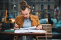 Stylish young man studying in urban cafe Royalty Free Stock Photo