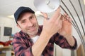 Handsome male electrician changing light bulb Royalty Free Stock Photo