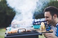 Handsome male grilling meat outdoor Royalty Free Stock Photo