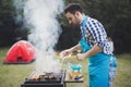 Handsome male grilling meat outdoor Royalty Free Stock Photo