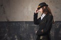 Handsome male in a hat-cylinder, Steam punk style. Retro man portrait over grunge background. Royalty Free Stock Photo