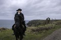 Handsome Male Horse Rider Regency 18th Century Poldark Costume with tin mine ruins and Atlantic ocean in background