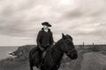 Handsome Male Horse Rider Regency 18th Century Poldark Costume with tin mine ruins and Atlantic ocean in background