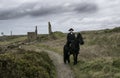 Handsome Male Horse Rider Regency 18th Century Poldark Costume with tin mine ruins and countryside in background Royalty Free Stock Photo