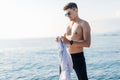 Handsome male model posing in front of a luxury yacht during summer vacation Royalty Free Stock Photo