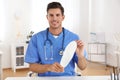 Handsome male orthopedist showing insole