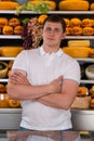 Handsome male owner of a cheese store Royalty Free Stock Photo