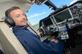 Handsome male pilot in cockpit