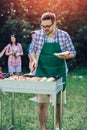 Man preparing barbecue outdoors for friends Royalty Free Stock Photo