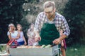 Male preparing barbecue outdoors for friends Royalty Free Stock Photo