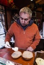 Male seller chef baker with sandwich on kitchen