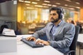 Handsome male technical support operator working at his workplace in call center office. Royalty Free Stock Photo