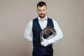 Handsome male waiter, white shirt, holds a silver tray, hand behind his back. Concept of wait staff serving customers in a Royalty Free Stock Photo