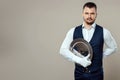 Handsome male waiter, white shirt, holds a silver tray, hand behind his back. Concept of wait staff serving customers in a Royalty Free Stock Photo