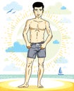 Handsome man adult standing on tropical beach in bright shorts.