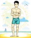 Handsome man adult standing on tropical beach in bright shorts.