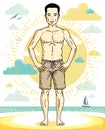 Handsome man adult standing on tropical beach in bright shorts.