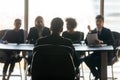 Handsome man applicant back sitting in front HR diverse businessmen. Royalty Free Stock Photo