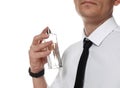 Handsome man applying perfume on neck against white background Royalty Free Stock Photo