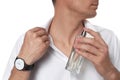 Handsome man applying perfume on neck against white background Royalty Free Stock Photo