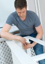 Handsome man assembling furniture. Royalty Free Stock Photo