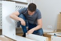 Handsome man assembling furniture. Royalty Free Stock Photo