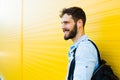 Handsome man with backpack on yellow Royalty Free Stock Photo