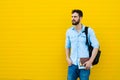 Handsome man with backpack on yellow Royalty Free Stock Photo