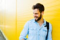 Handsome man with backpack on yellow Royalty Free Stock Photo