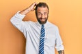 Handsome man with beard and long hair wearing business clothes confuse and wonder about question Royalty Free Stock Photo