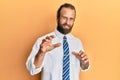 Handsome man with beard and long hair wearing business clothes disgusted expression, displeased and fearful doing disgust face Royalty Free Stock Photo