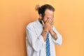 Handsome man with beard and long hair wearing business clothes with sad expression covering face with hands while crying Royalty Free Stock Photo