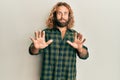 Handsome man with beard and long hair wearing casual clothes afraid and terrified with fear expression stop gesture with hands, Royalty Free Stock Photo