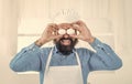 handsome man with beard and moustache cooking food. professional restaurant cook baking. skilled baker cooking eggs in Royalty Free Stock Photo